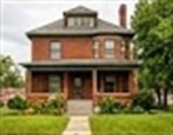 A historic red-brick Detroit home with a front porch